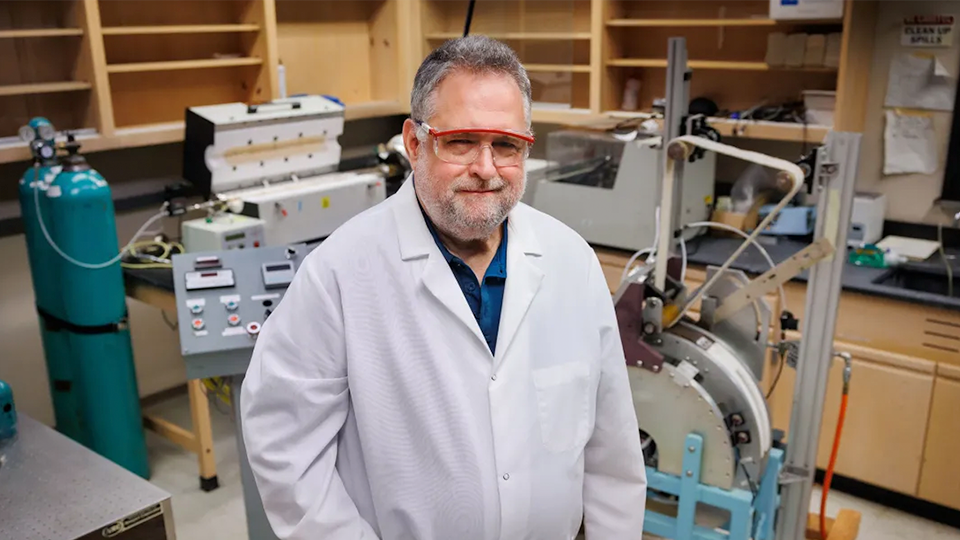 Researcher in lab with tanks and equipment